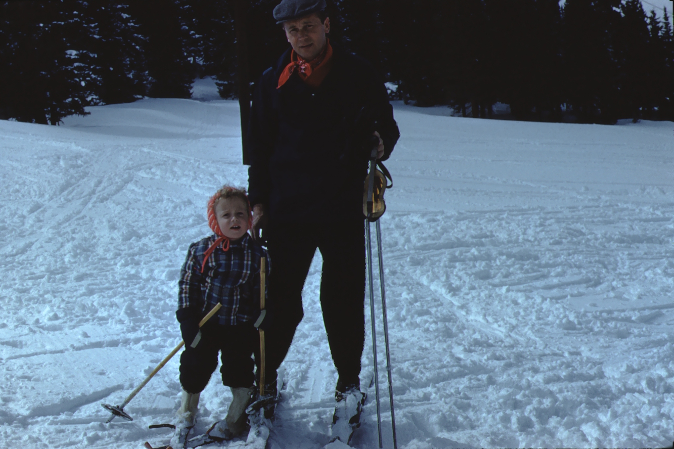 Vintage photo of a girl and her father on the ski slopes