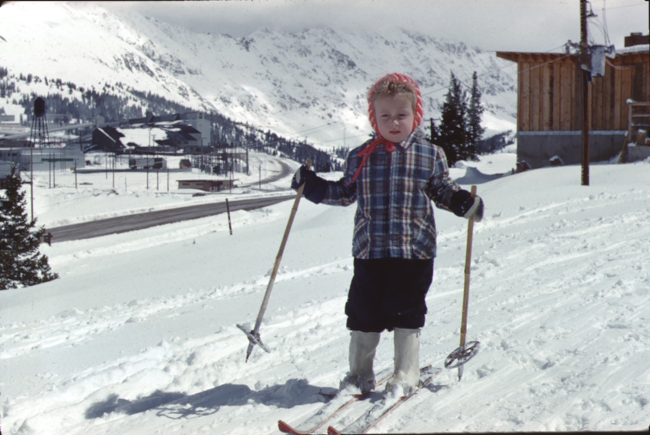 Vintage photo of a girl skiing in front of the closed molybdenum mine in Climax, Colorado